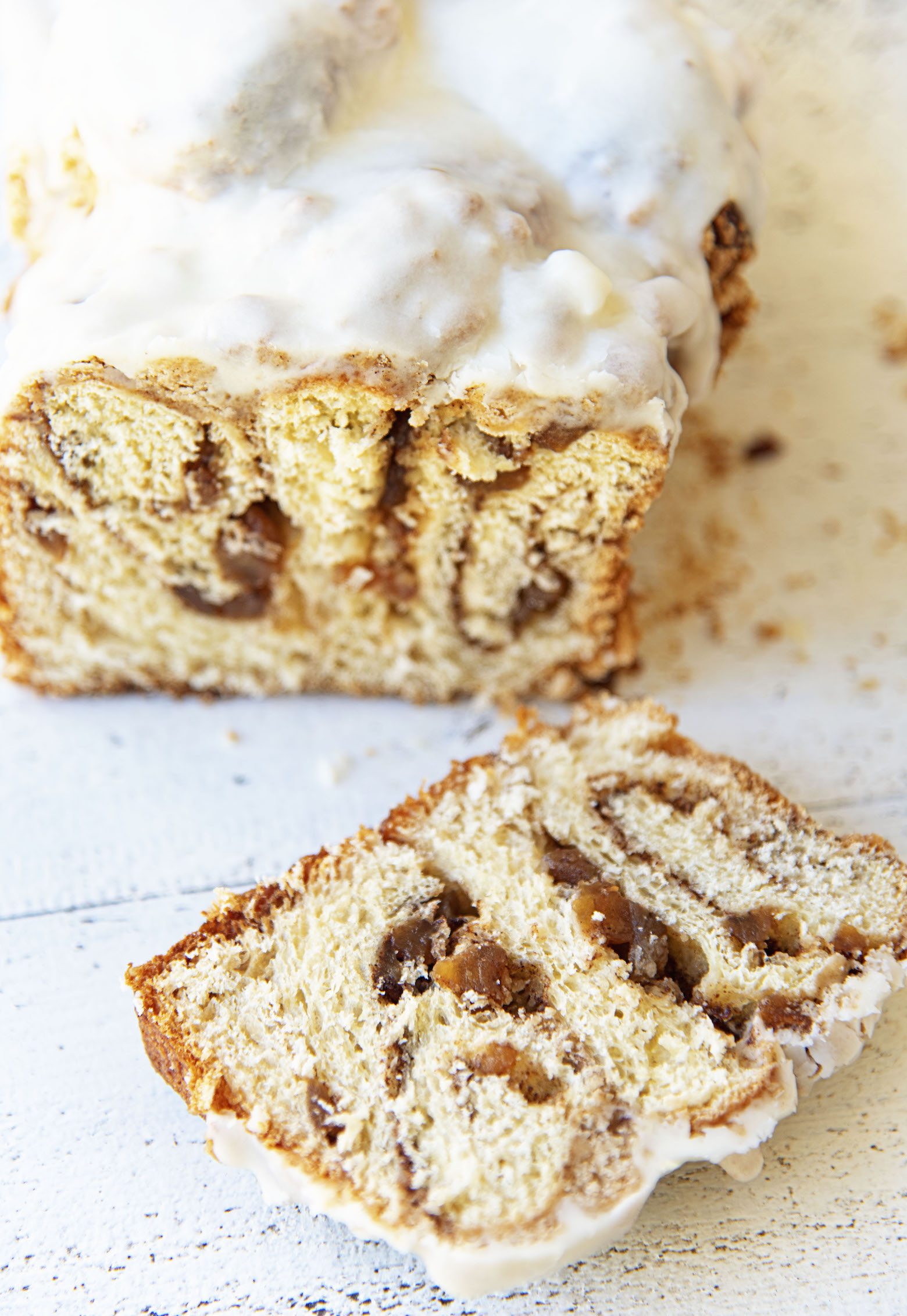Apple Crumb Cinnamon Roll Loaf with slice cut to show the inside of the bread. 