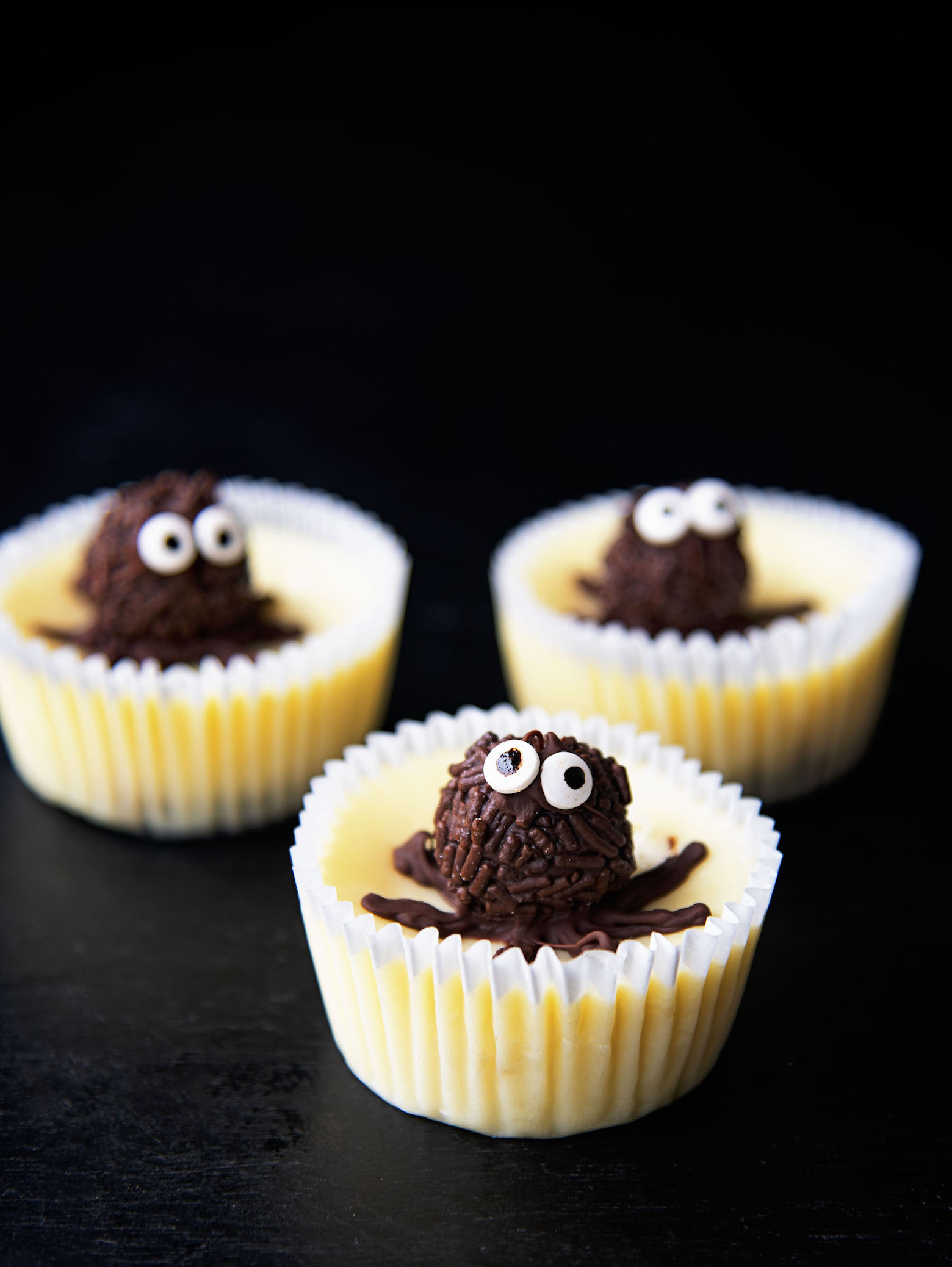 Side view of three Chocolate Truffle Spider Cheesecake Bites