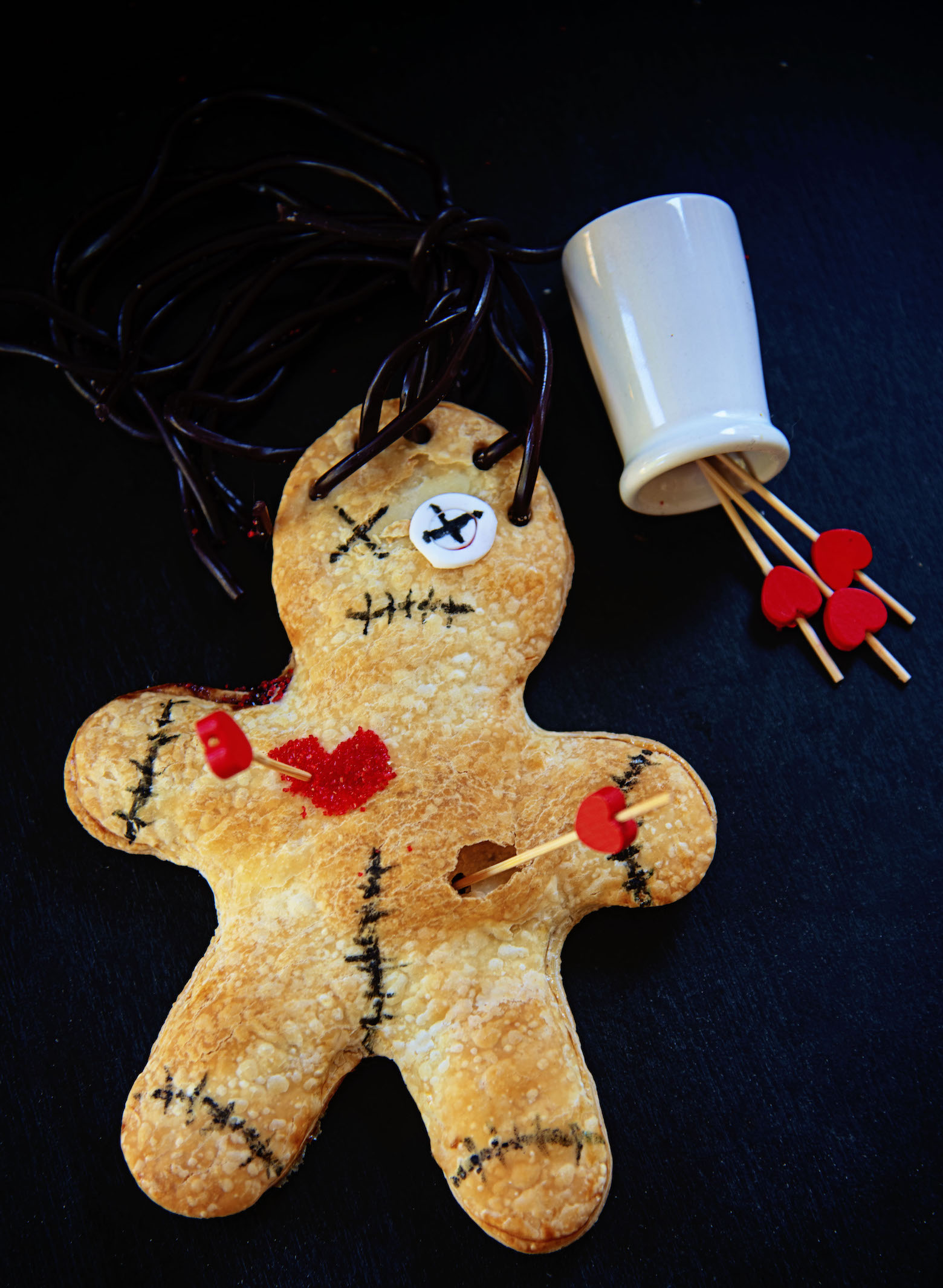 Single Voodoo Doll Hand Pie with a jar of spilled heart toothpicks 
