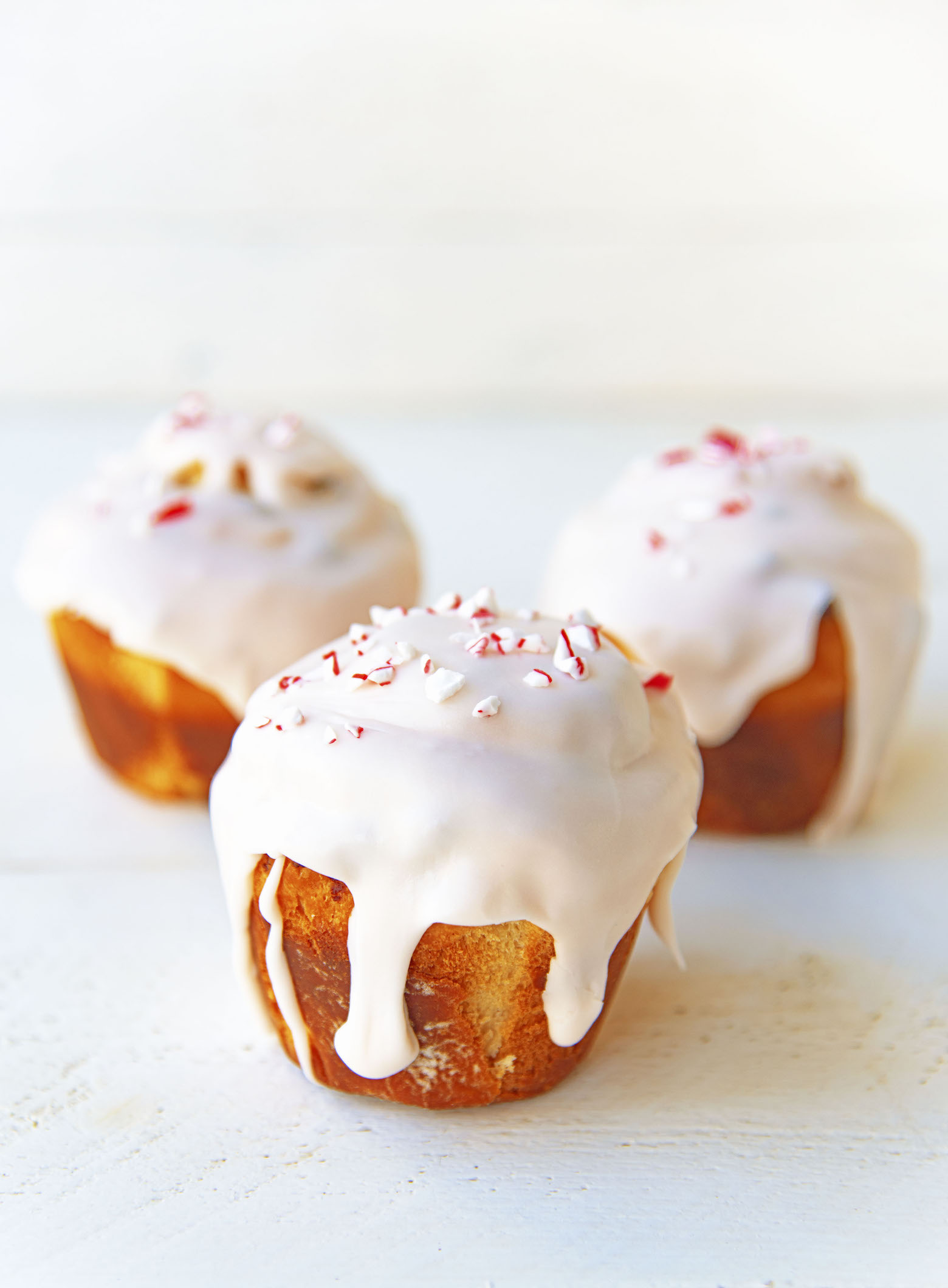 Three Candy Cane Sweet Rolls with the first roll being in focus