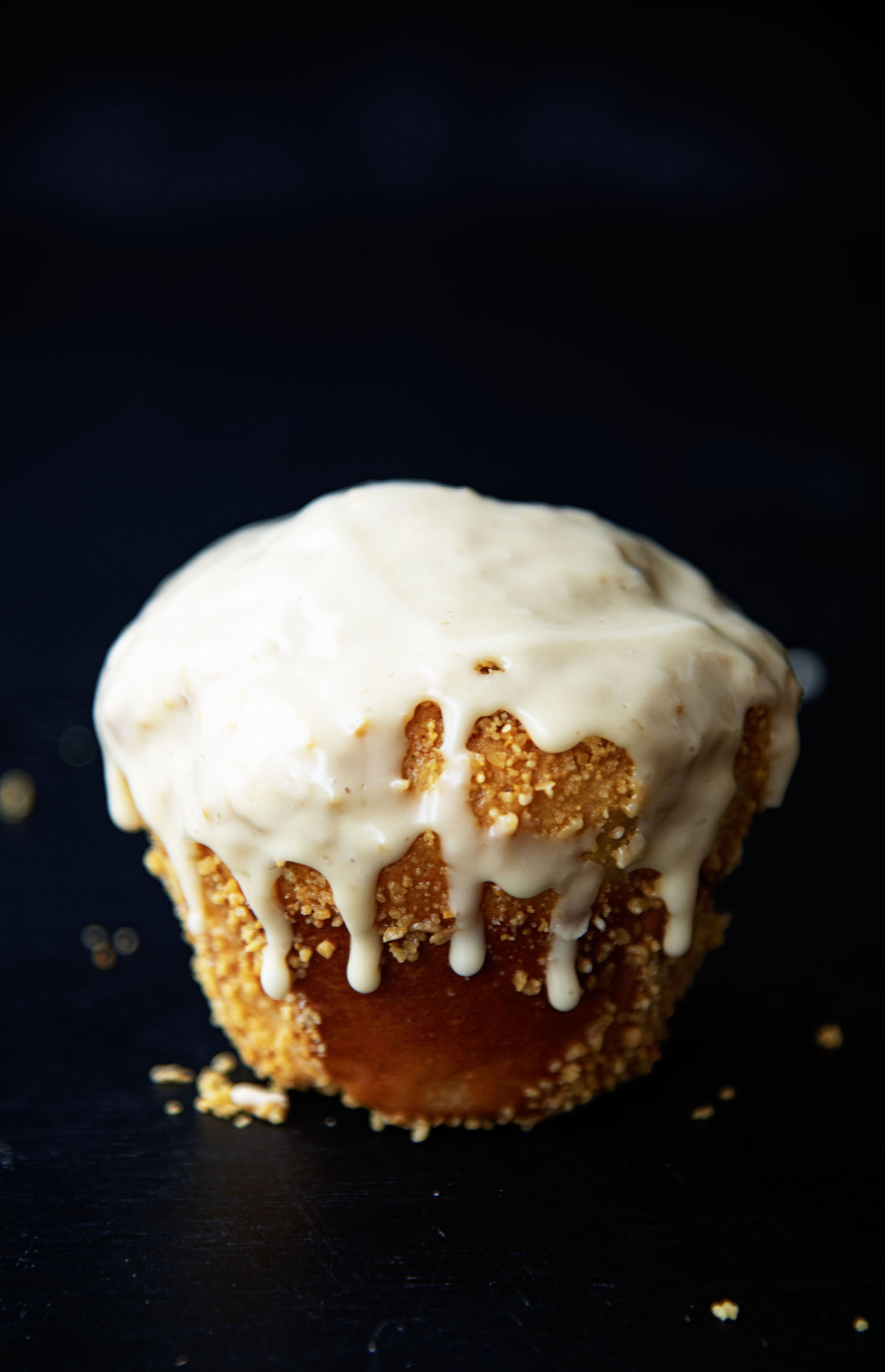 Single whole Salted Maple Cinnamon Roll with glaze dripping down