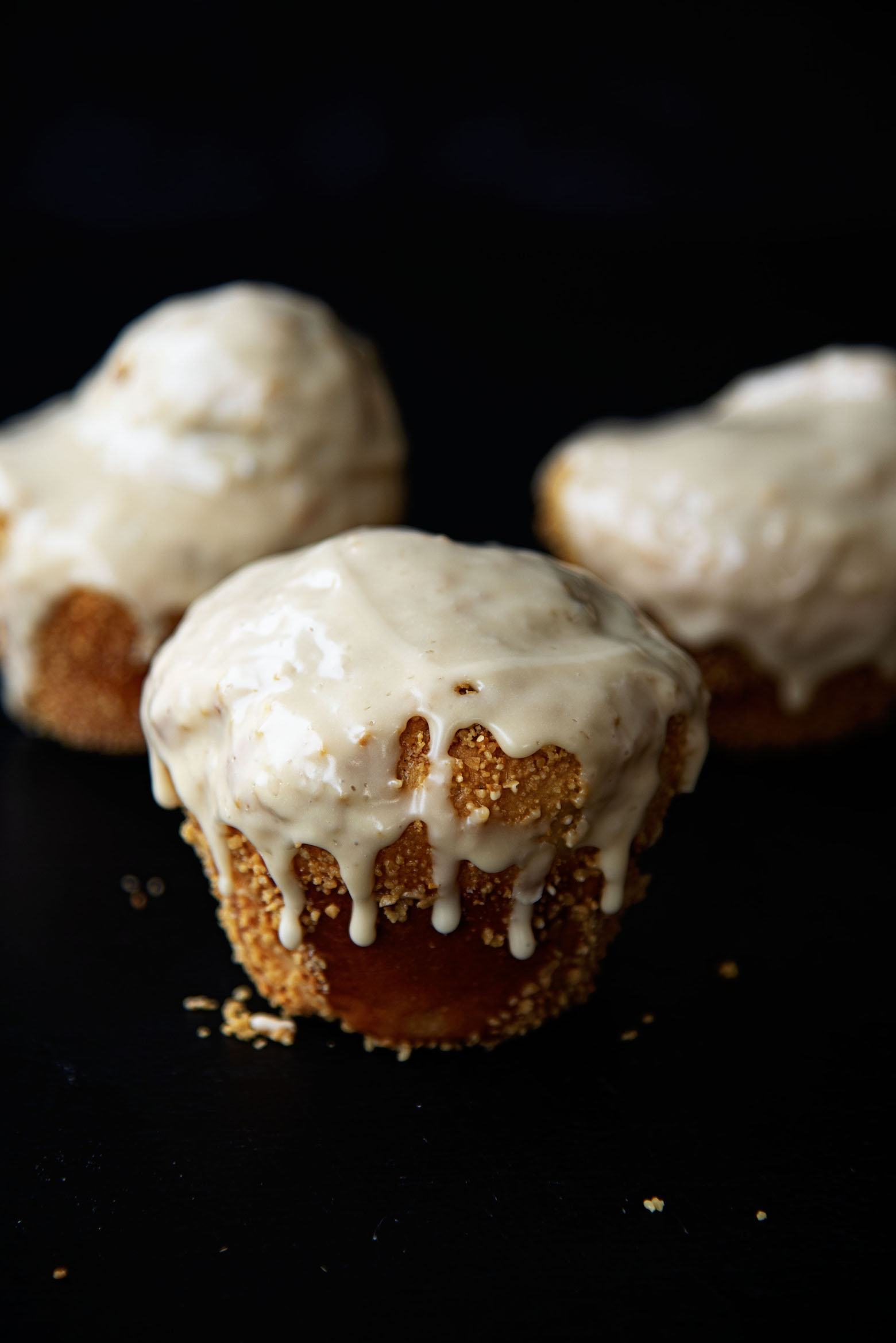 Three Salted Maple Cinnamon Rolls with one roll upfront as the main focus