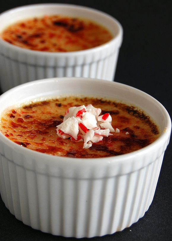 Two creme brulee with the first one in focus. 