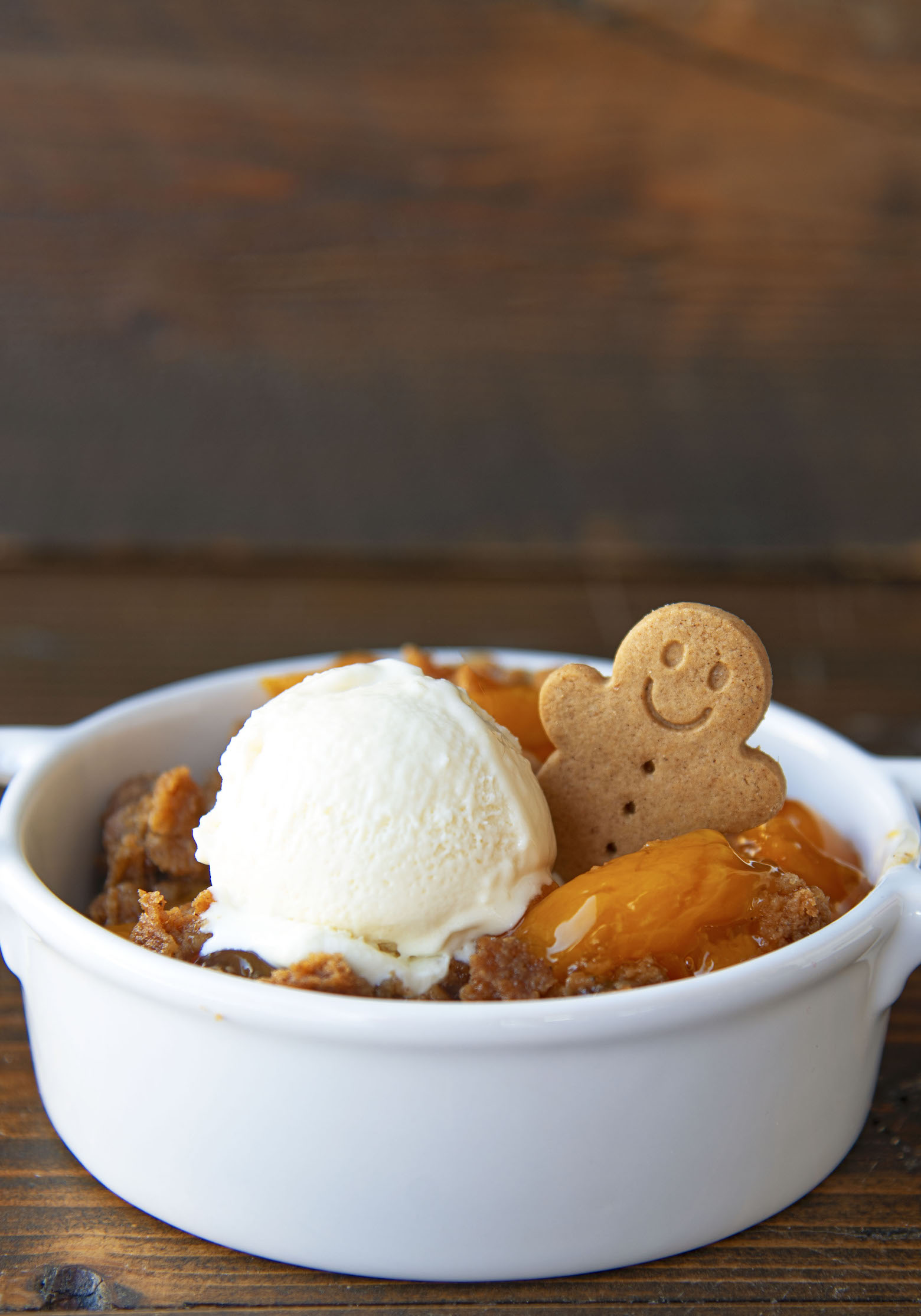 Side view of the dump cake with a gingerbread man cookie peeking out