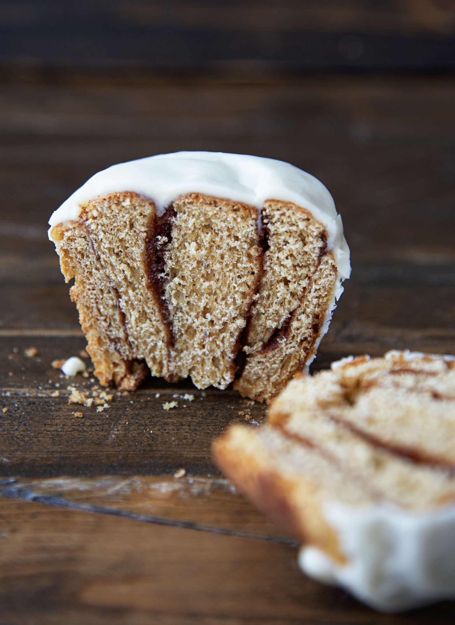 Single Orange Gingerbread Cinnamon Roll cut down the middle exposing the filing. 