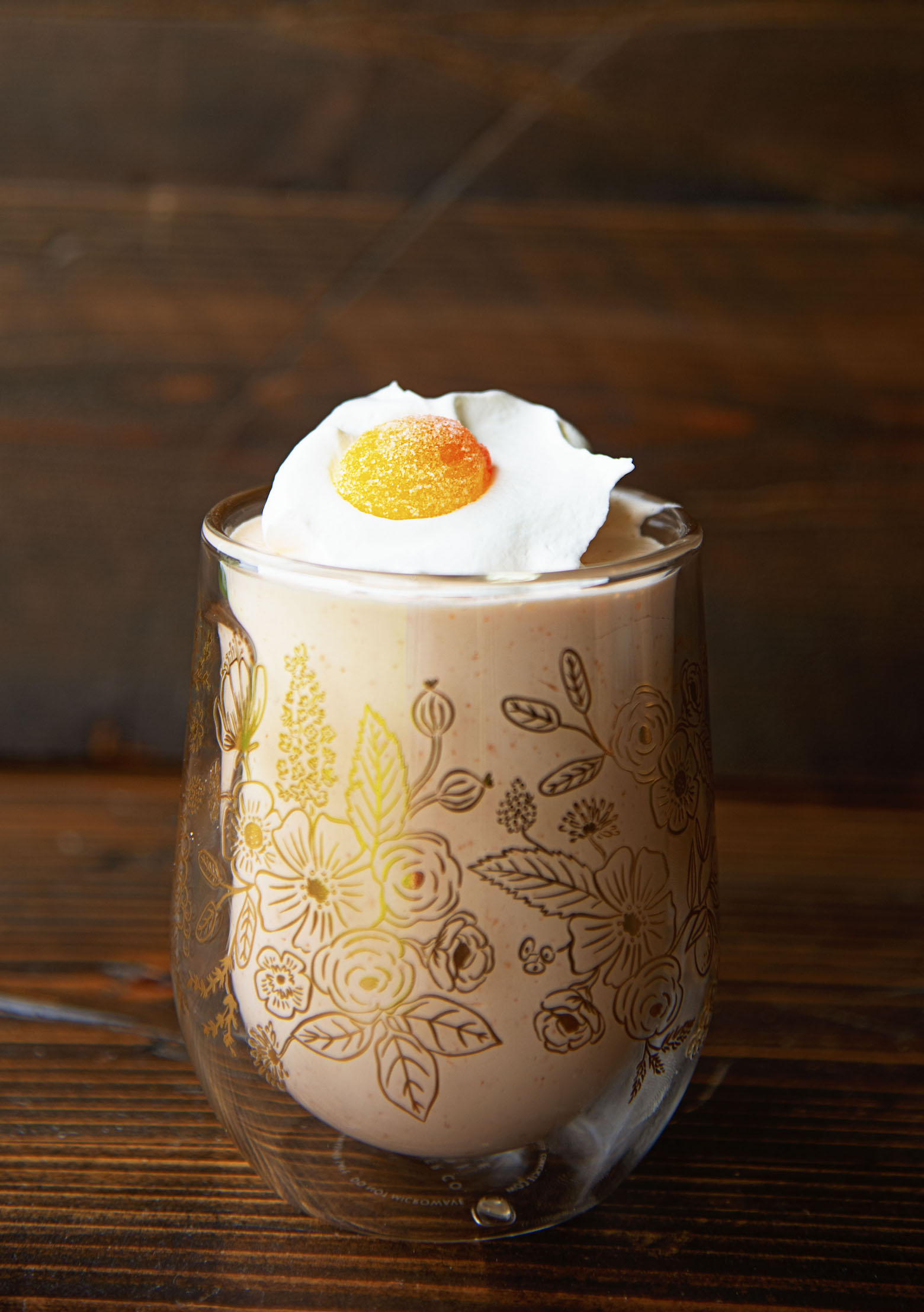 Side view of a single Peach Bellini Jello Salad in a gold floral glass