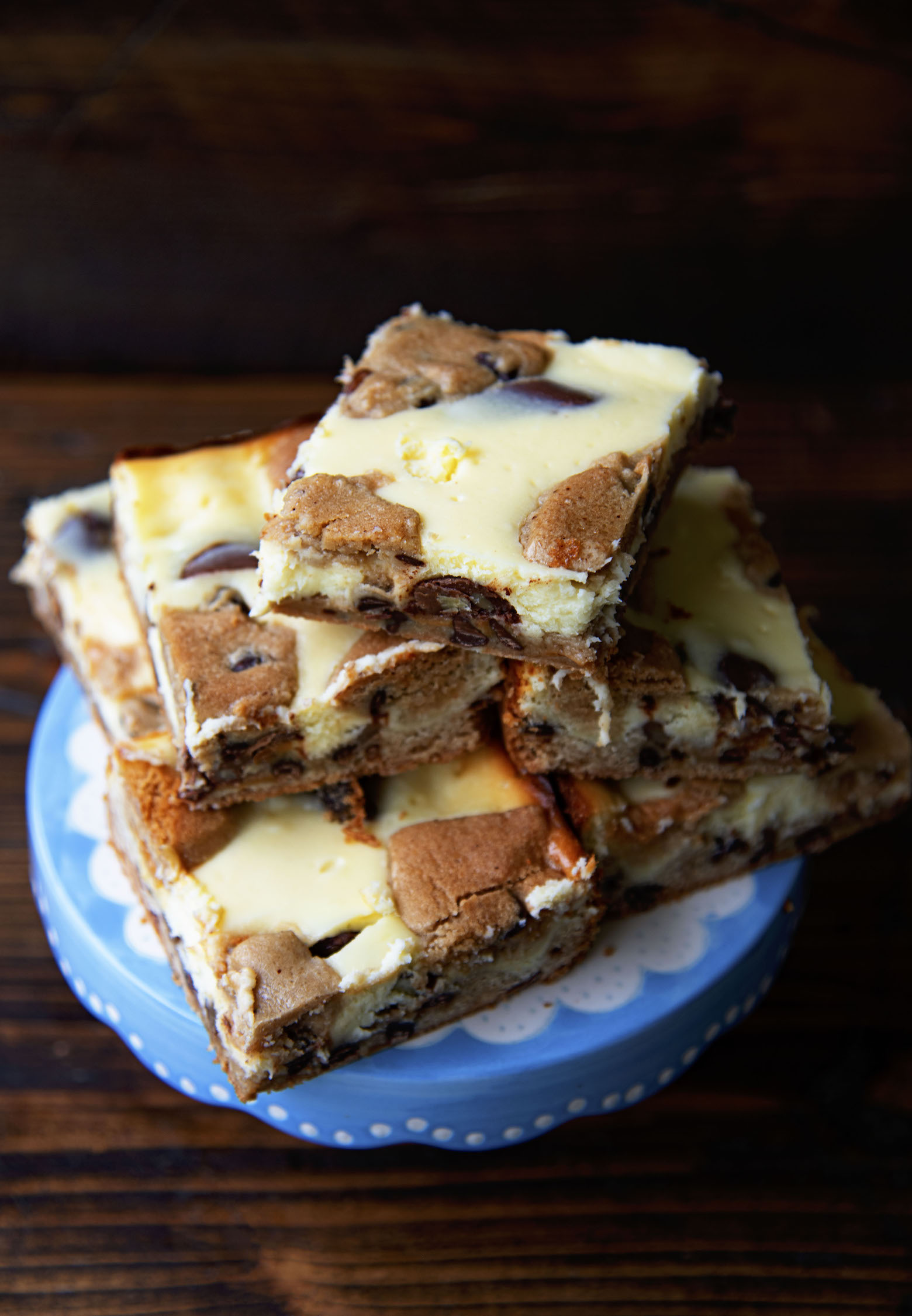 Overhead shot of Caramel Turtle Cheesecake Bars on a cake plate. 