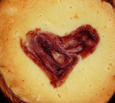 Close up of the raspberry heart in the middle of the cheesecake