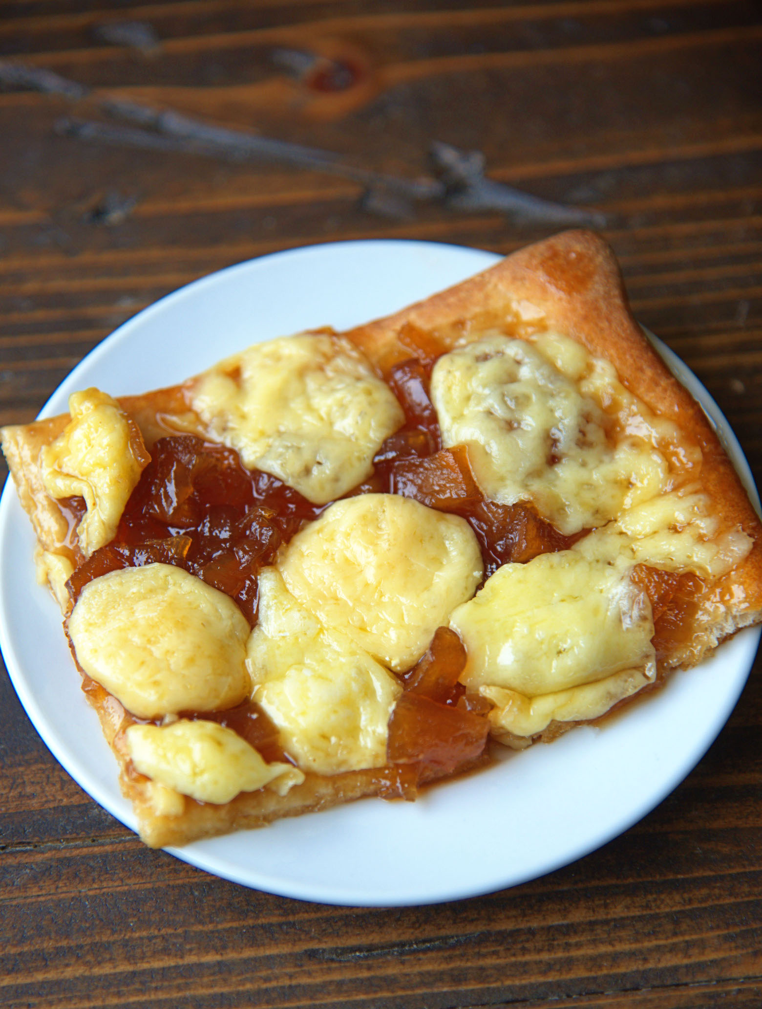 Up close shot of a piece of the flatbread on a small white plate.