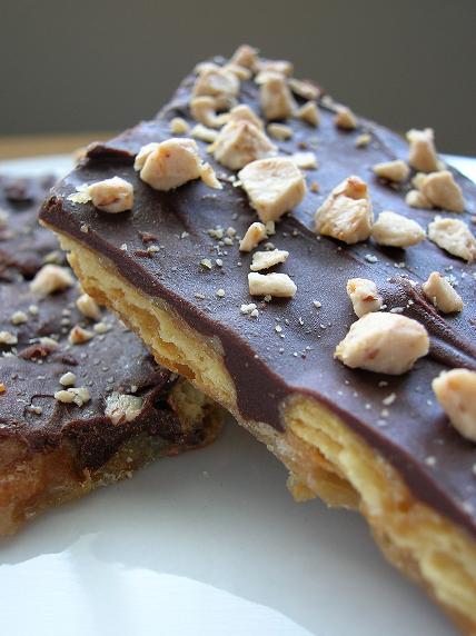 CLose up of a piece of cracker toffee broken in half.