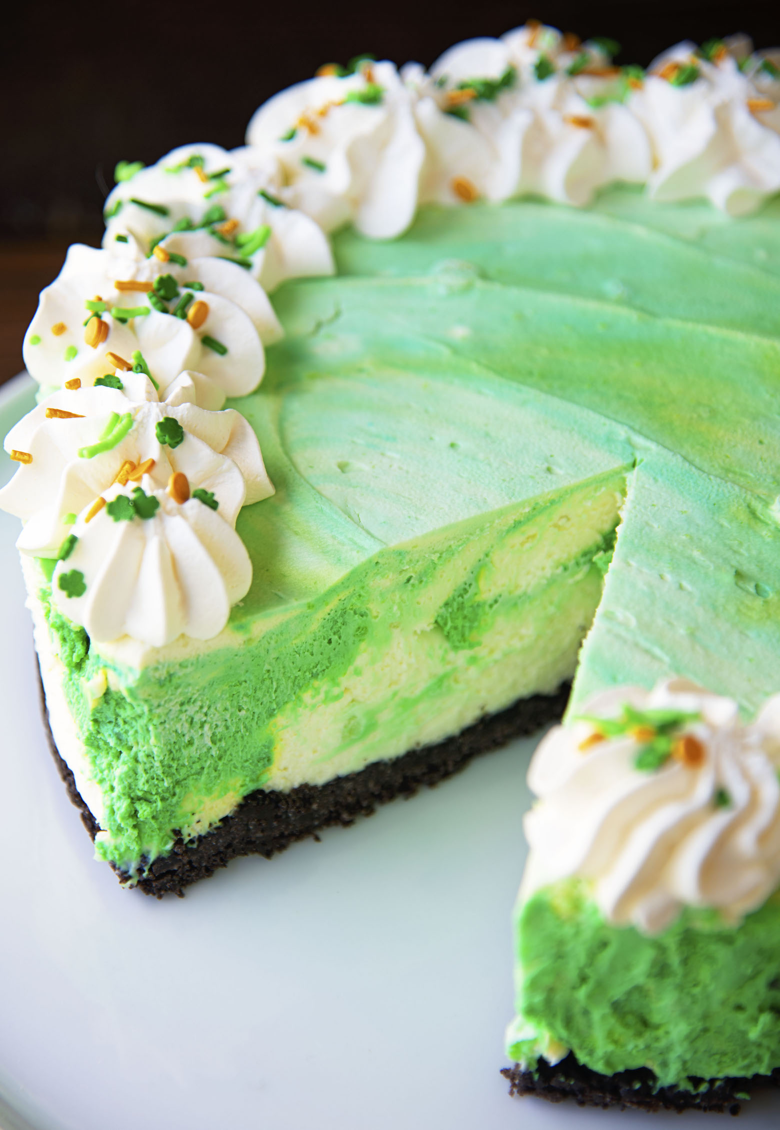 Close up of mousse cake with a slice taken out of it exposing the inside of the cake. 