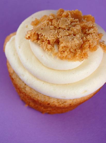 Single cupcake with close up on the Peanut Butter Crunch with purple background