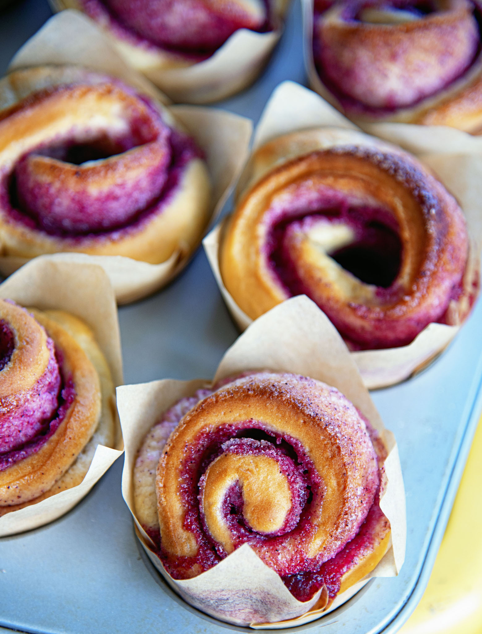 Close up of the swirl of the Kir Royale Sugar Buns in the metal pan they were baked in.