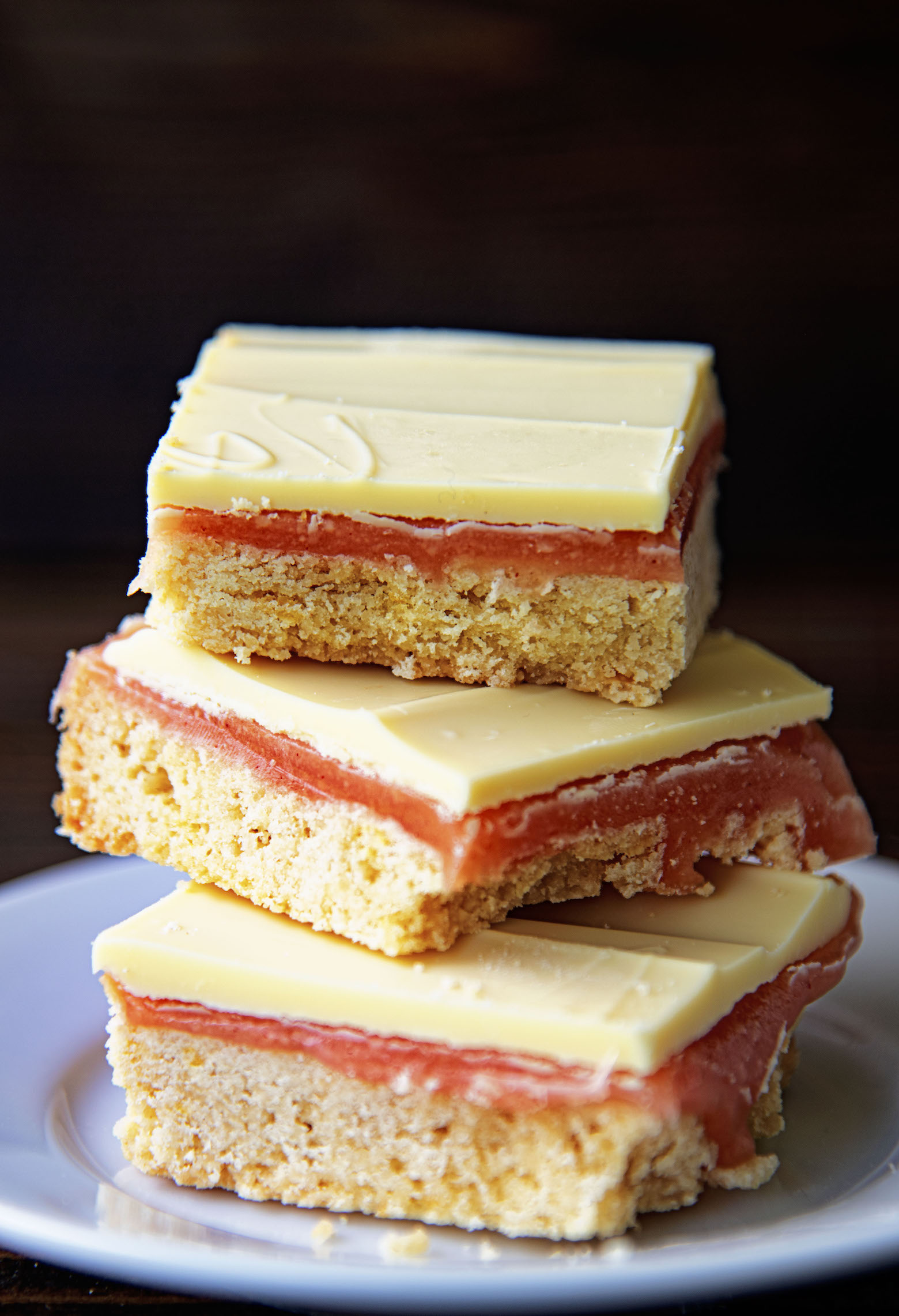 Three Strawberry Lemonade Caramel Bars stacked on top of each other.
