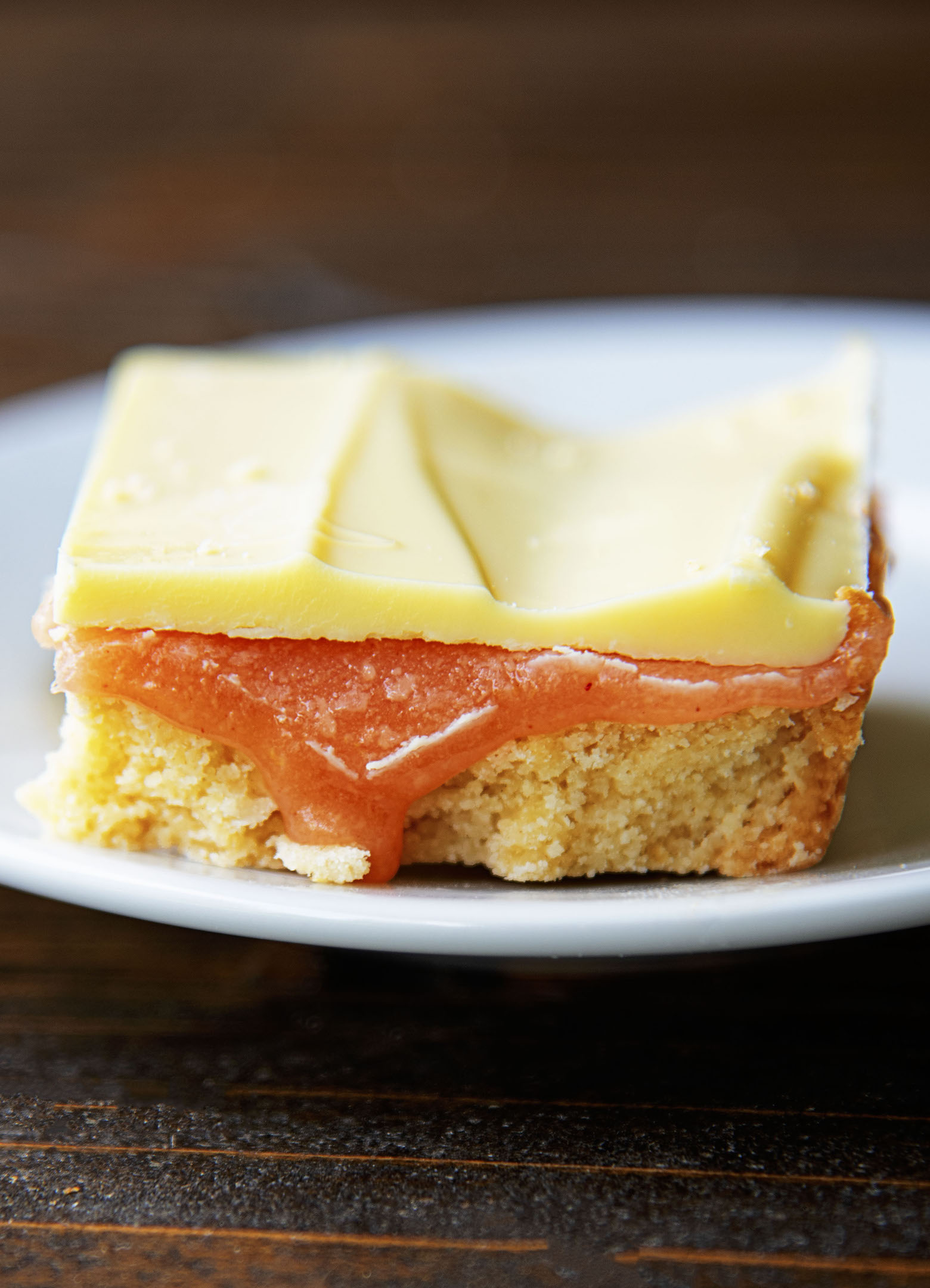 Close up of a single Strawberry Lemonade Caramel Bar with caramel dripping out. 