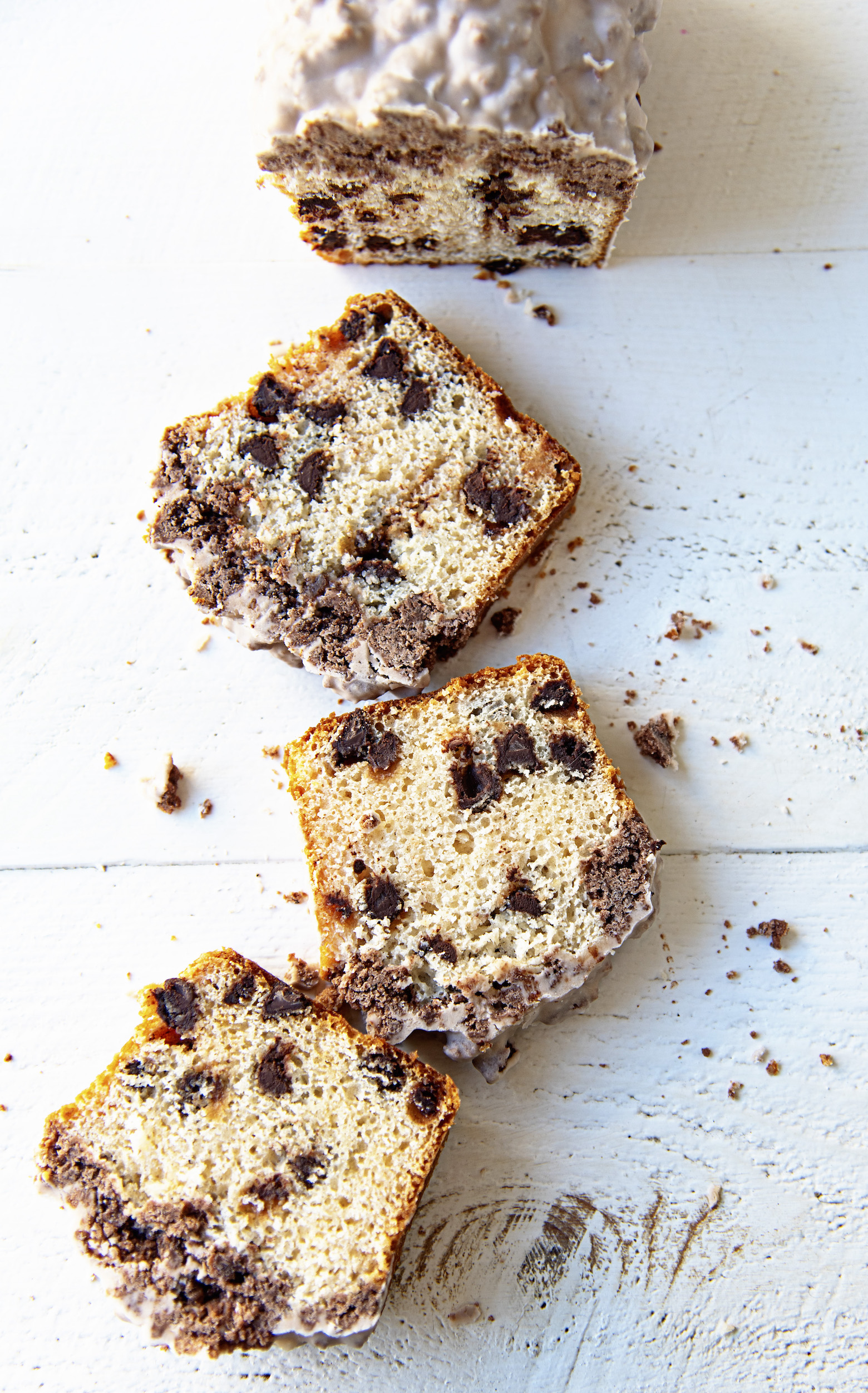 Overhead shot of a Chocolate Milkshake Crumb Cake cut with three slices out in front of it.