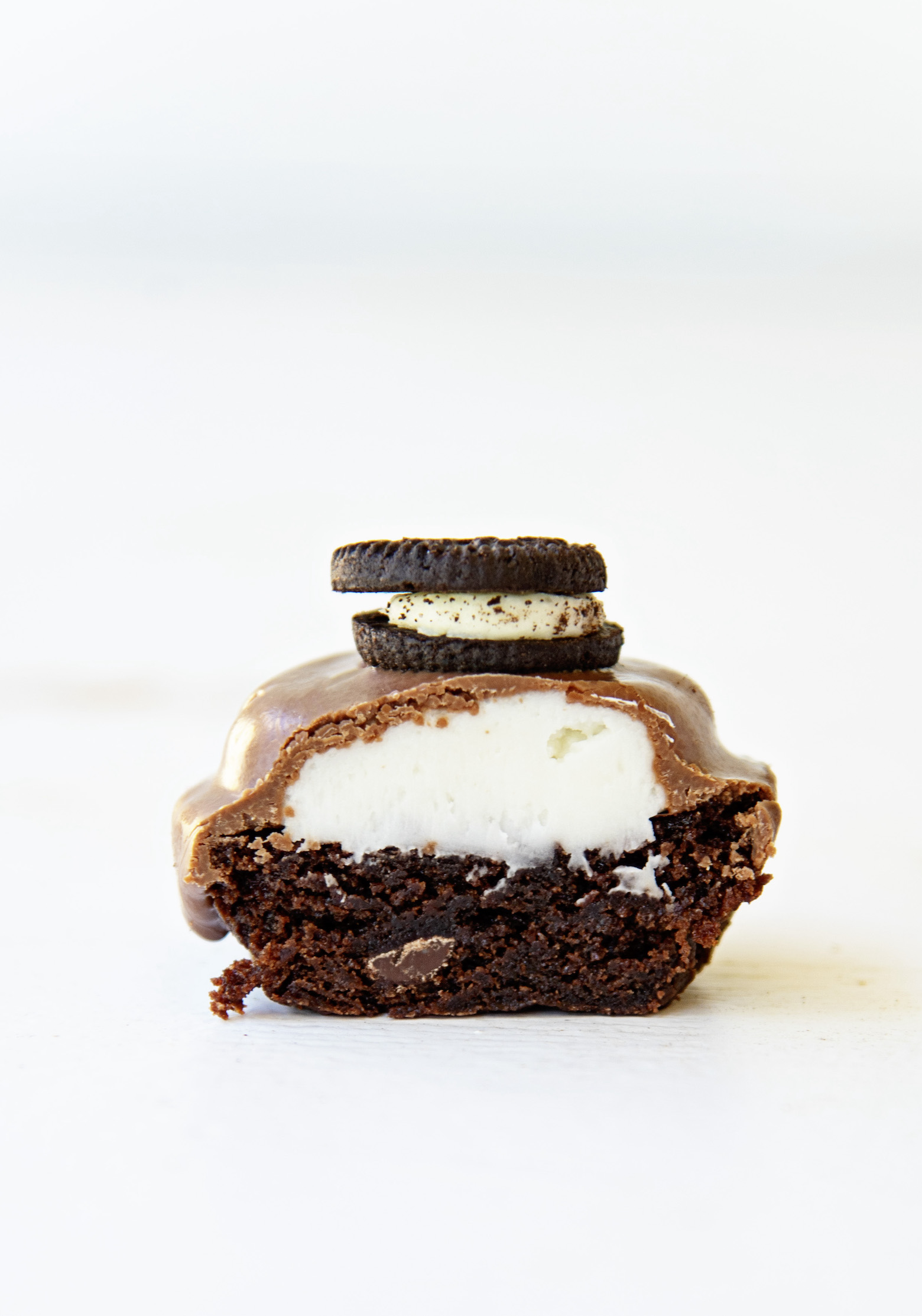 Single Double Stuffed Brownie Bite cut in half exposing the filling.