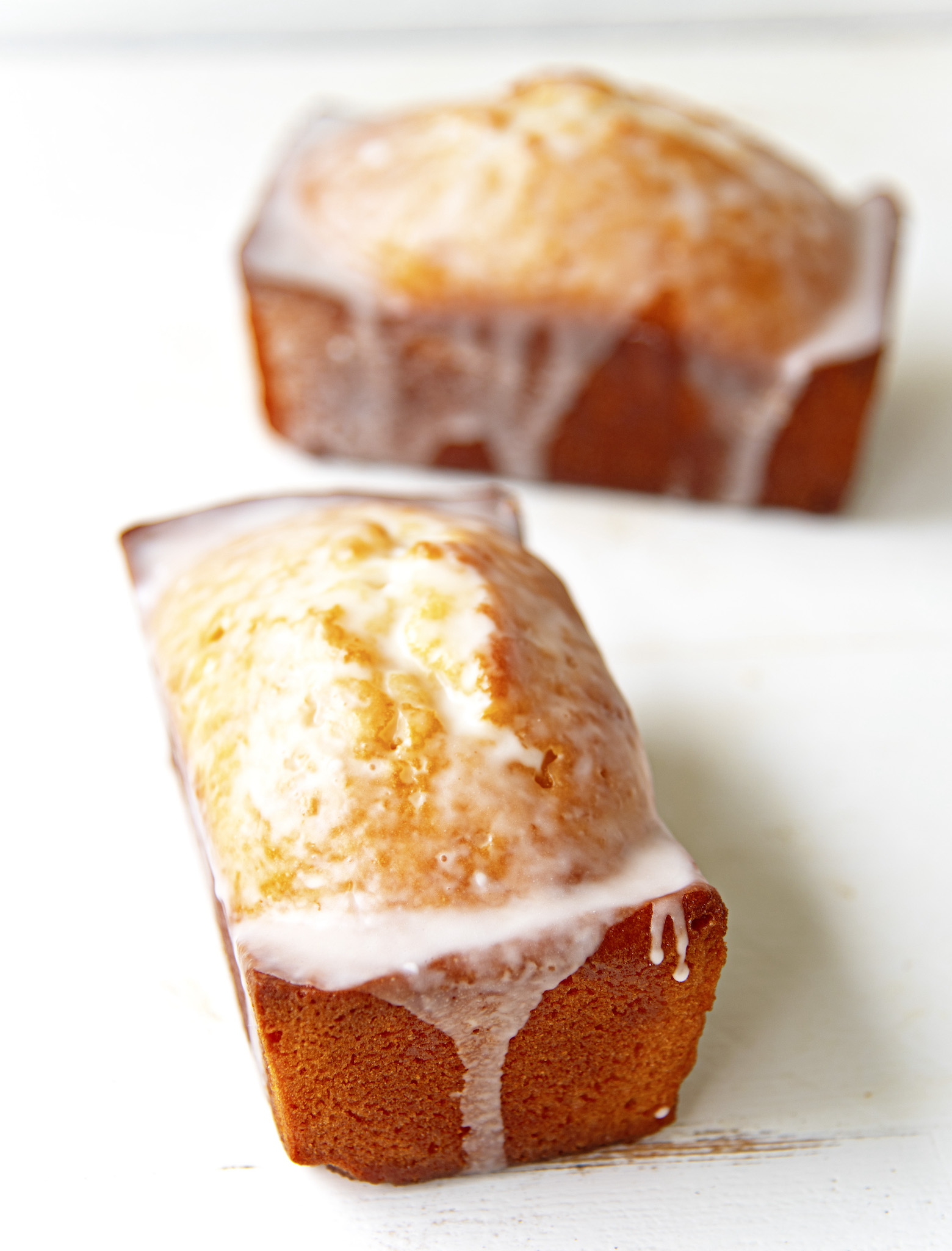 Two whole loaves with glaze on them. 