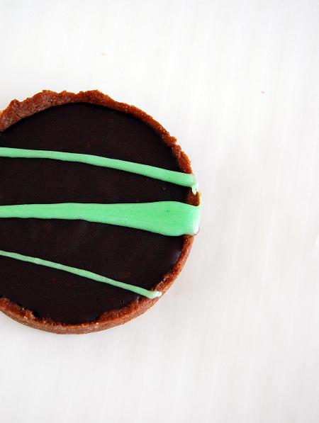 Overhead shot of the Chocolate Mint Grasshopper Tart with stripes of green marshmallow across the chocolate portion of the tart. 