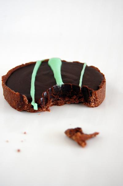 Side view of tart with a piece bitten into.