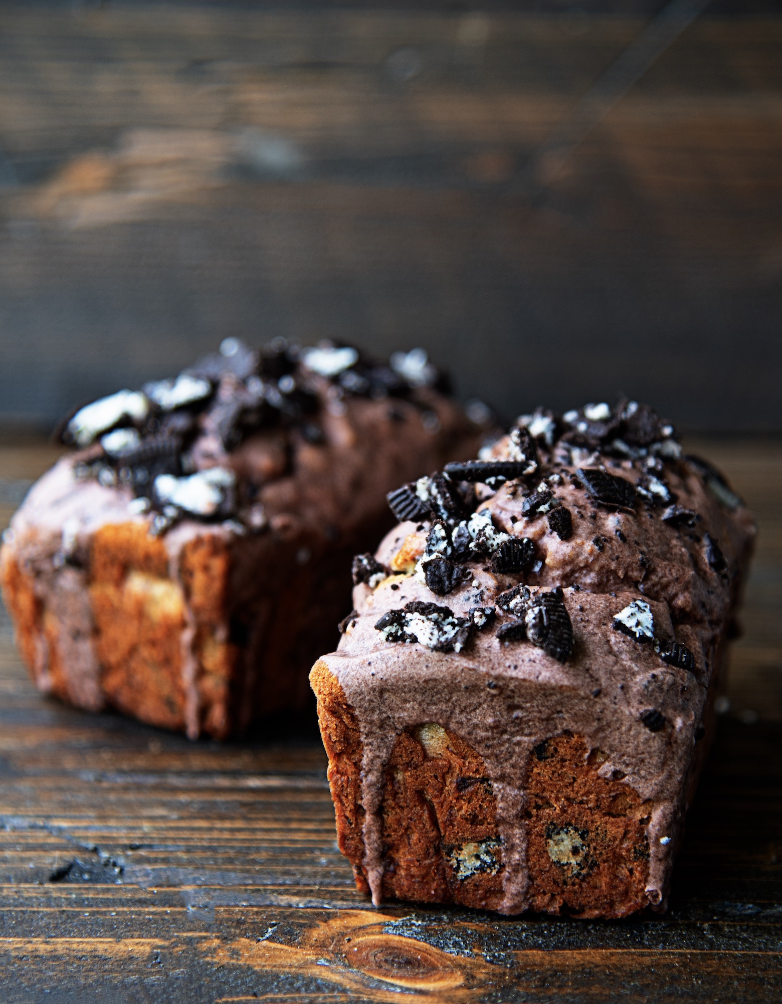 Side view of two whole cookies and cream banana breads side by side. 