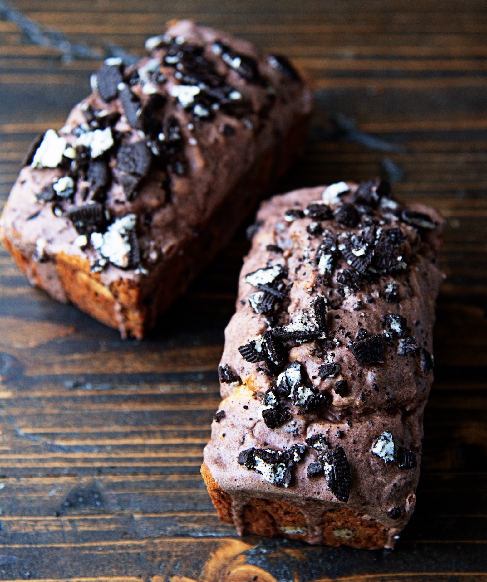 Two whole cookies and cream banana breads side by side. 