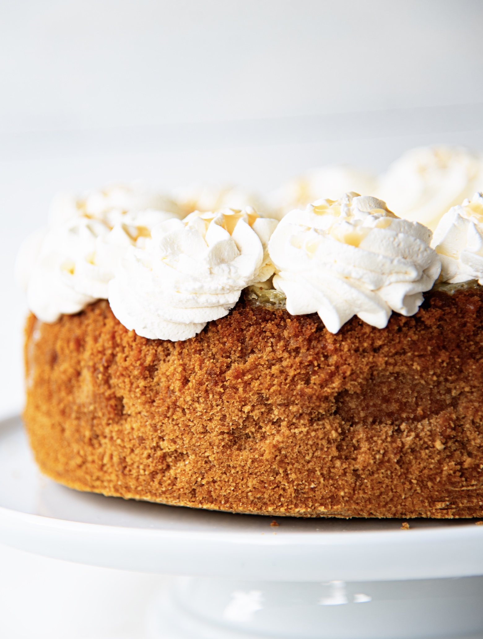 Side view of the crust topped with whipped cream swirls.