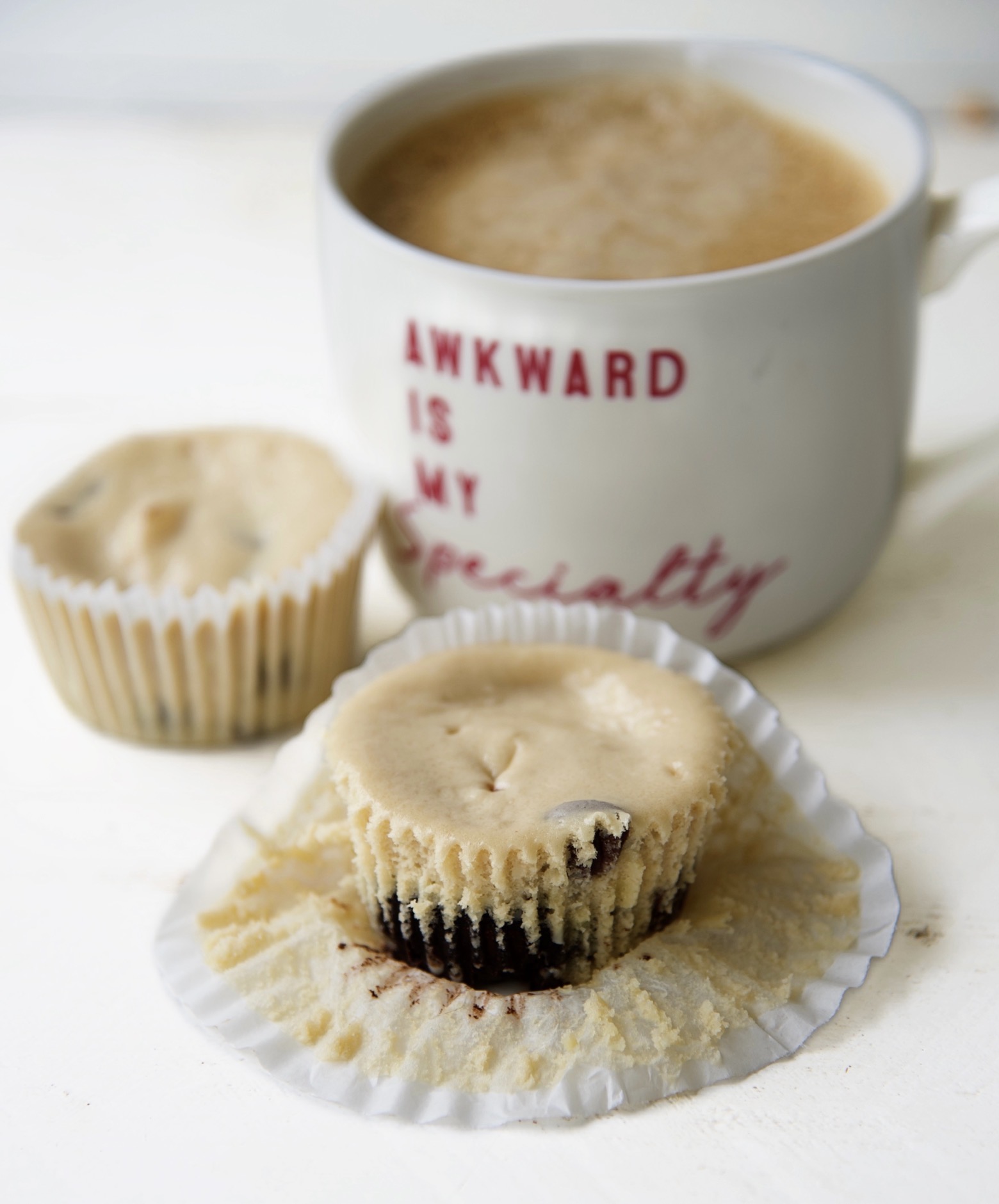 Two Coffee and Donuts Cheesecake Bites With a cup of coffee in the upper right hand corner with a cup that reads Awkward is my specialty.