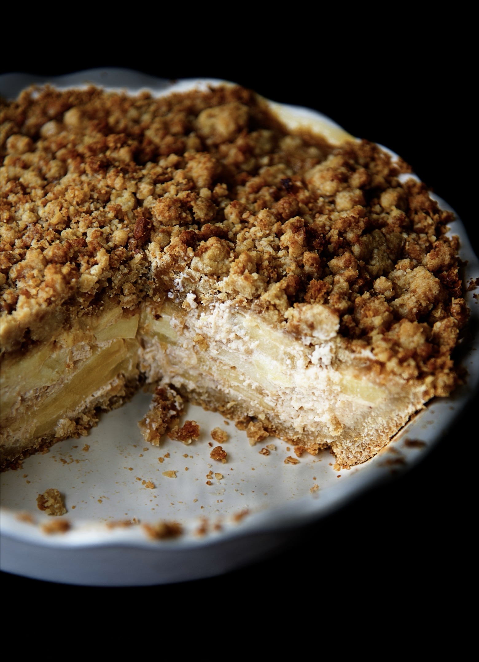 Close up of the cut pie in the dish showing the layers of the apples in the filling.