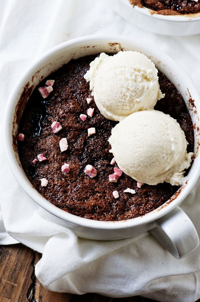 Close up of the cobbler with sprinkled peppermint crunch chips on top with two scoops of ice cream. 