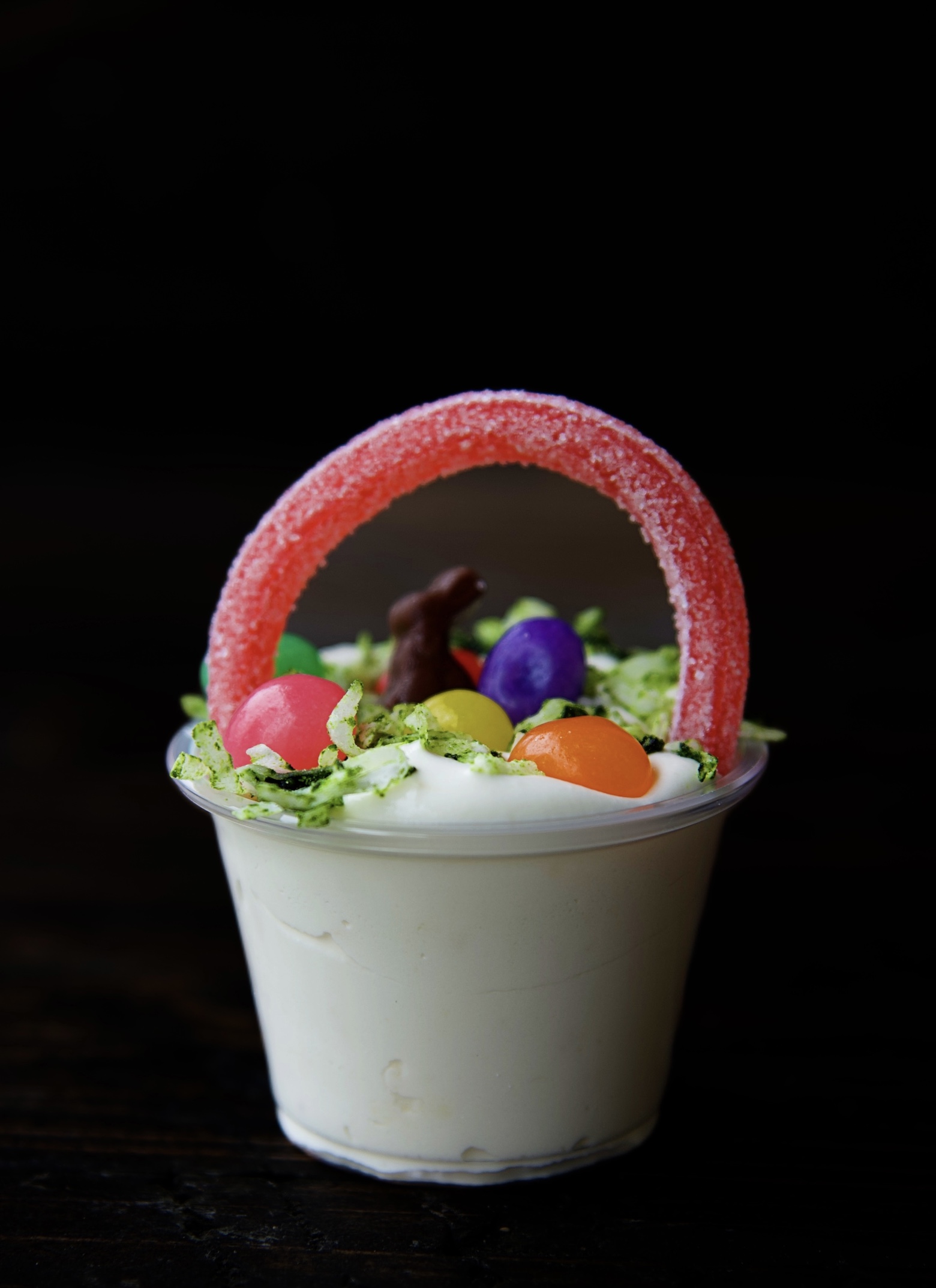 Side view of a single pudding shot with a close up of the Easter basket top. 
